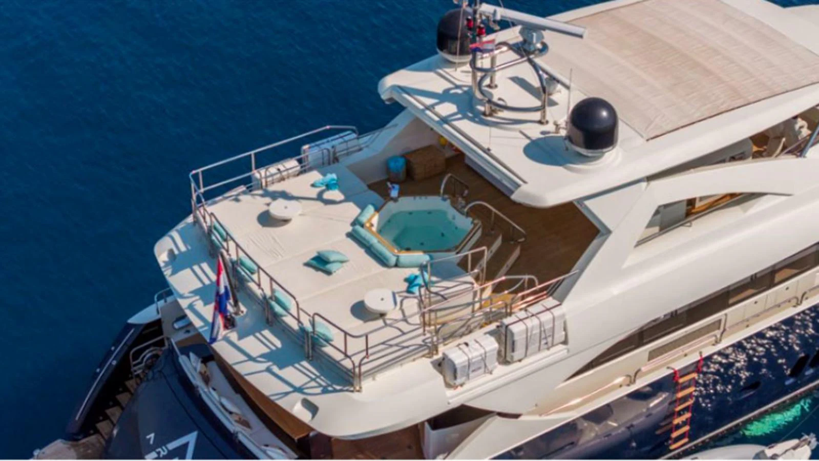 The yacht's sundeck features a luxurious hot tub surrounded by comfortable seating, perfect for relaxation. aboard ARAGO Yacht for Sale