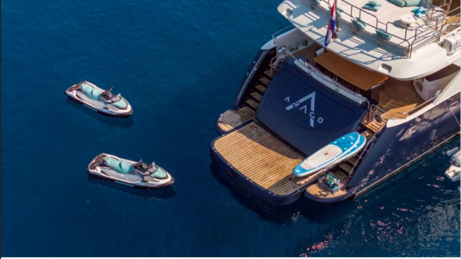 The aft deck of the yacht features a spacious swim platform with water toys ready for adventure. aboard ARAGO Yacht for Sale