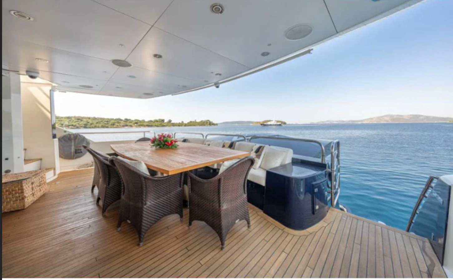 The aft deck offers a serene dining area with stunning ocean views. aboard ARAGO Yacht for Sale