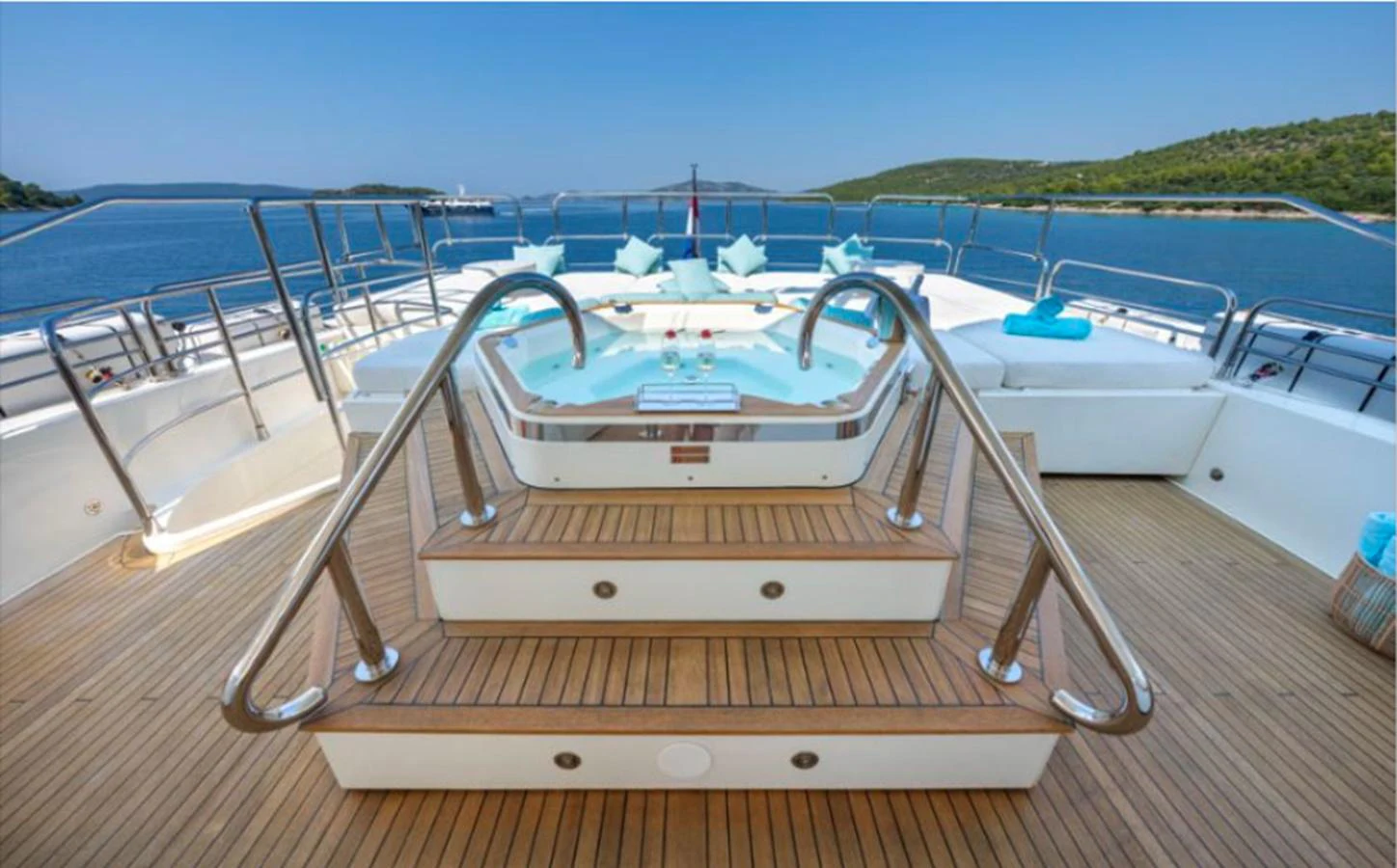 The sundeck features a luxurious jacuzzi surrounded by comfortable seating and scenic views. aboard ARAGO Yacht for Sale