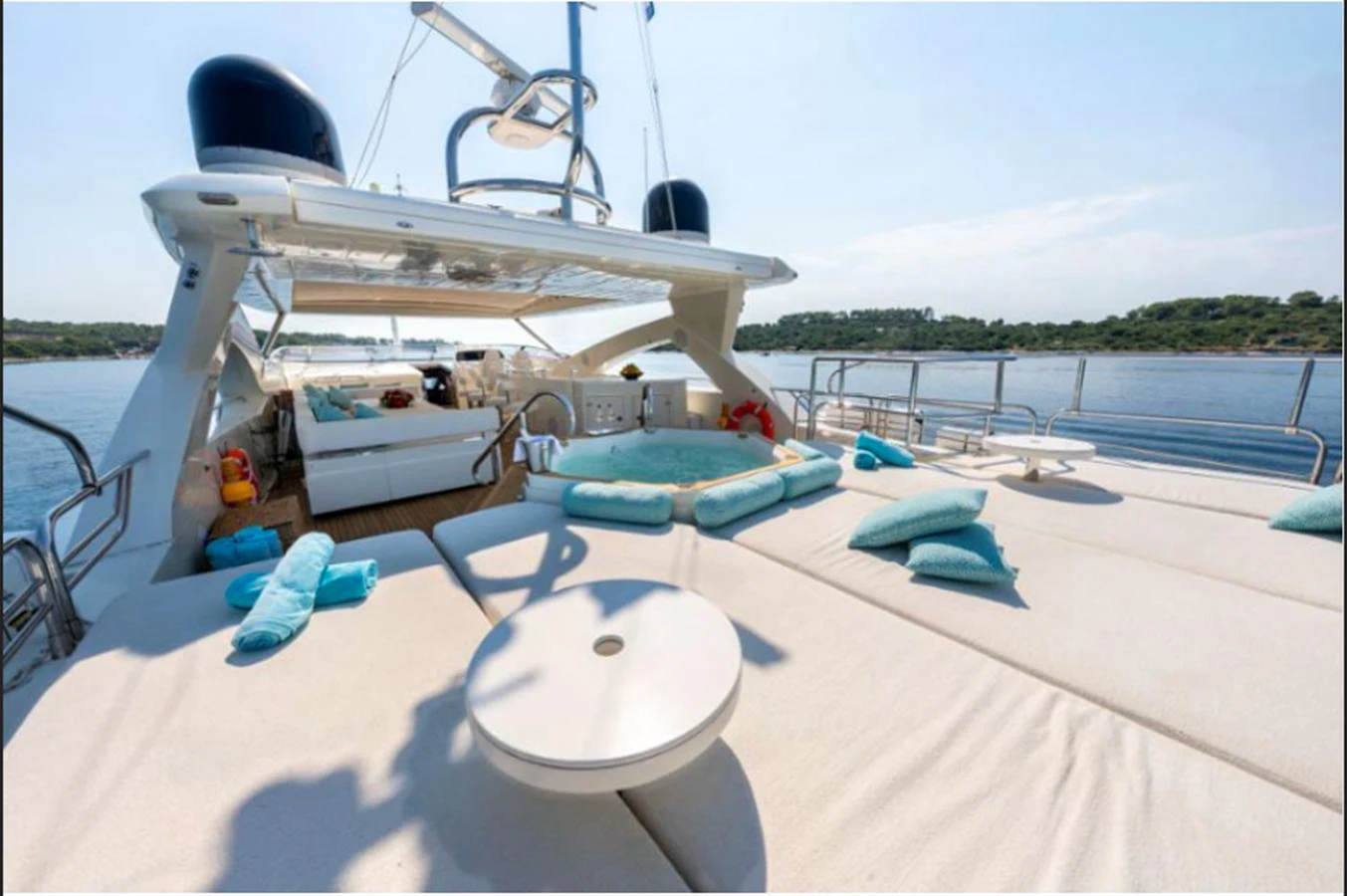 The sundeck offers a luxurious lounging area with plush seating and scenic views. aboard ARAGO Yacht for Sale