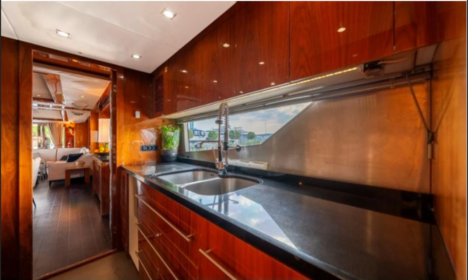 The yacht's galley features sleek wood cabinetry and modern appliances, providing a stylish and functional space for meal preparation. aboard ARAGO Yacht for Sale