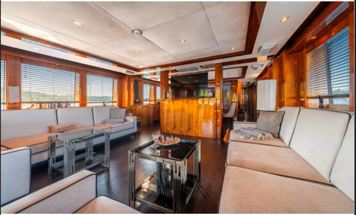 The spacious salon features elegant seating and large windows for natural light. aboard ARAGO Yacht for Sale