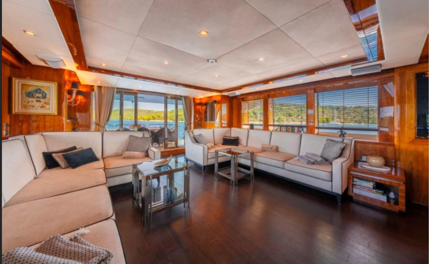 The spacious salon features elegant seating and panoramic windows offering stunning views. aboard ARAGO Yacht for Sale