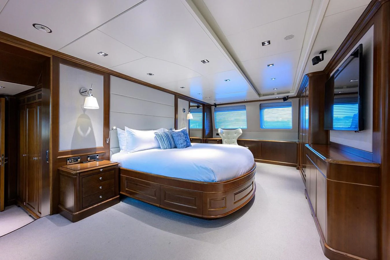 The master stateroom features a luxurious bed with elegant wood finishes and ample natural light. aboard BENETTI CLASSIC Yacht for Sale