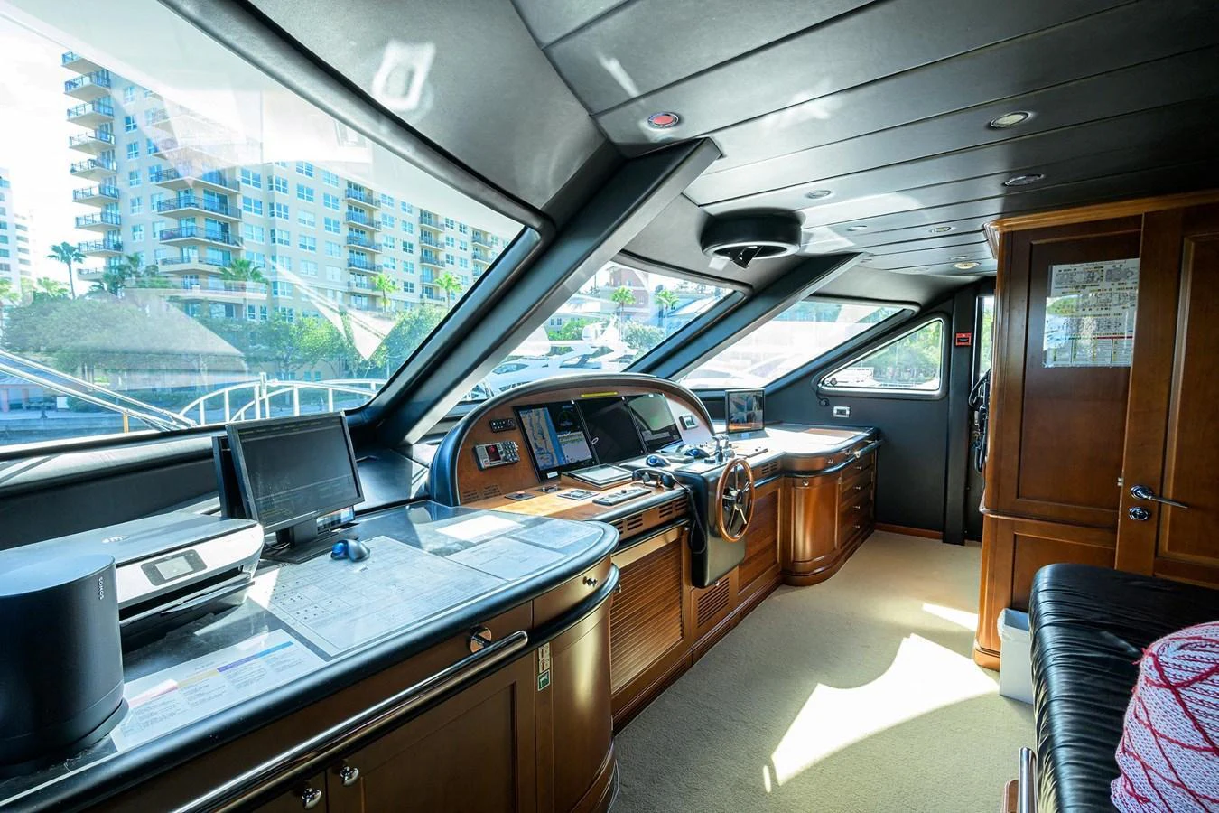 The helm station features advanced navigation equipment and luxurious wood finishes, offering a commanding view of the surroundings. aboard BENETTI CLASSIC Yacht for Sale