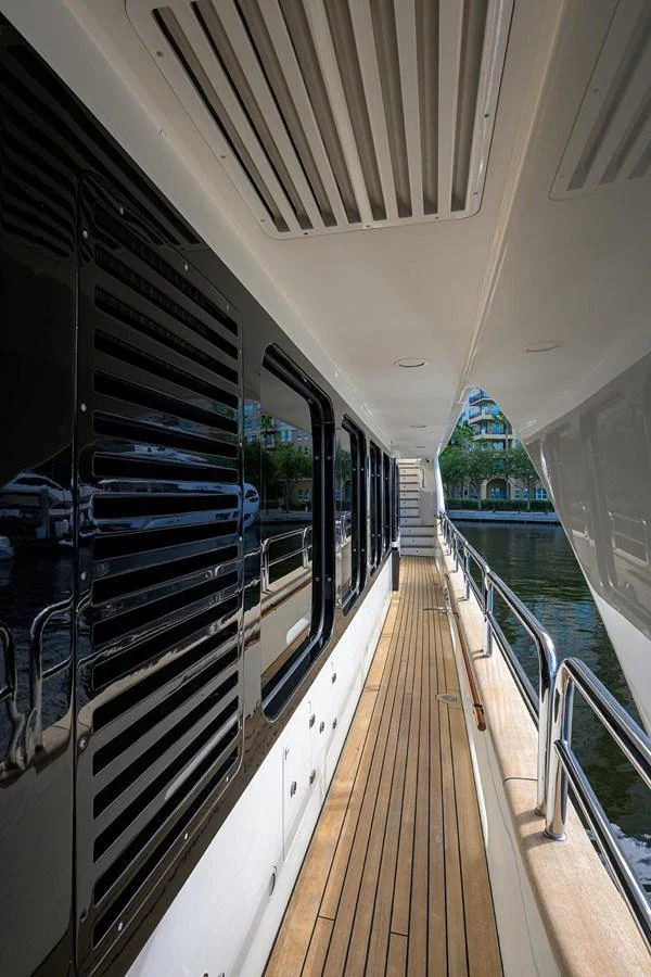 The side deck of the yacht features sleek lines and a polished wooden floor, offering a stylish passageway. aboard BENETTI CLASSIC Yacht for Sale