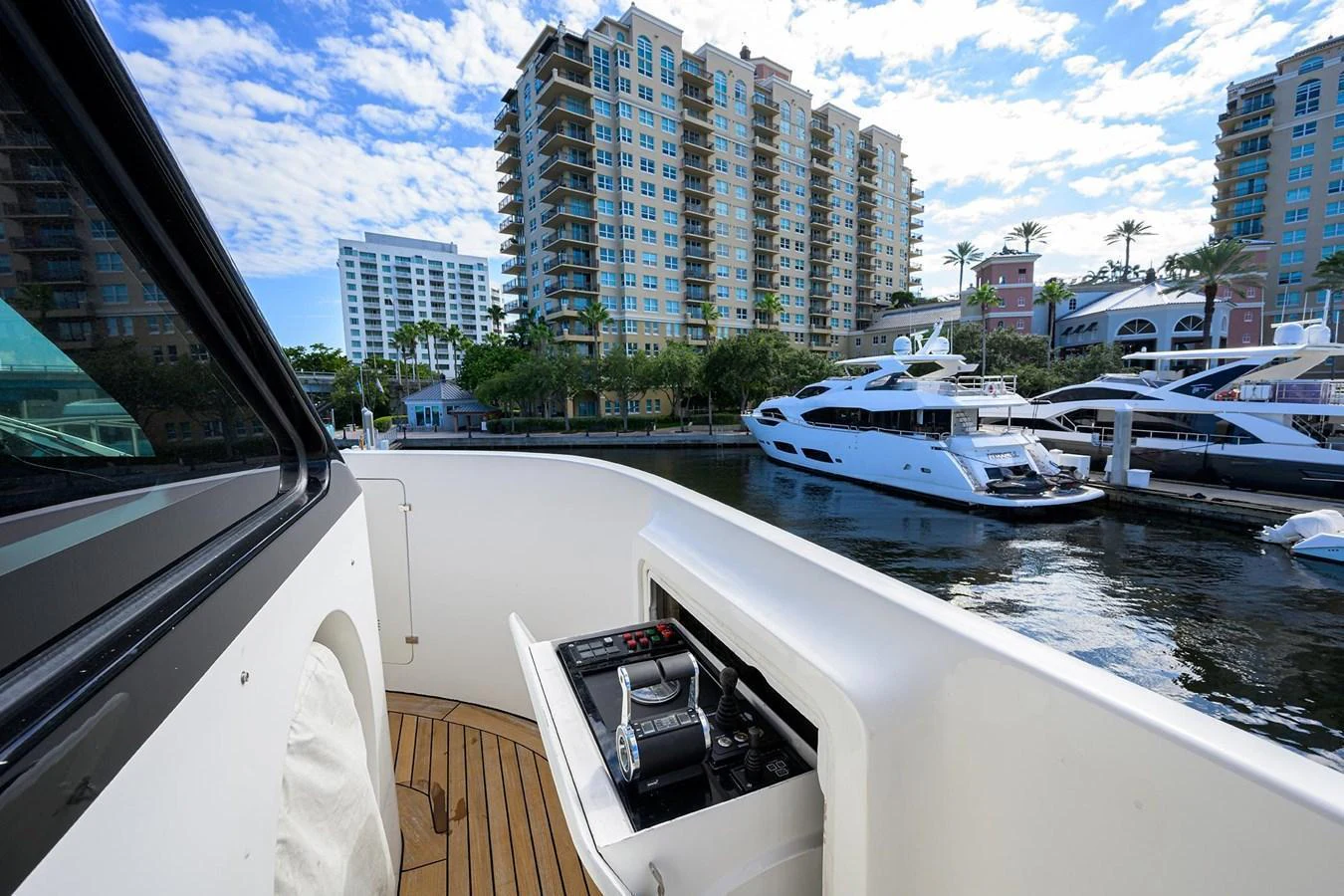 The yacht is docked in a marina with a view of nearby buildings and other yachts. aboard BENETTI CLASSIC Yacht for Sale
