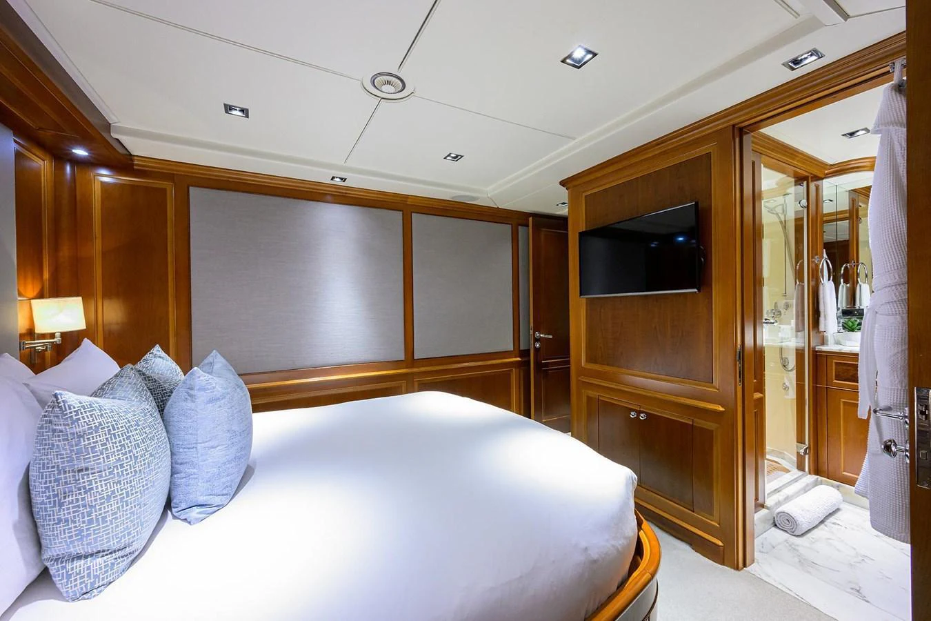 The stateroom features elegant wood paneling, a plush bed, and modern amenities for a luxurious stay. aboard BENETTI CLASSIC Yacht for Sale