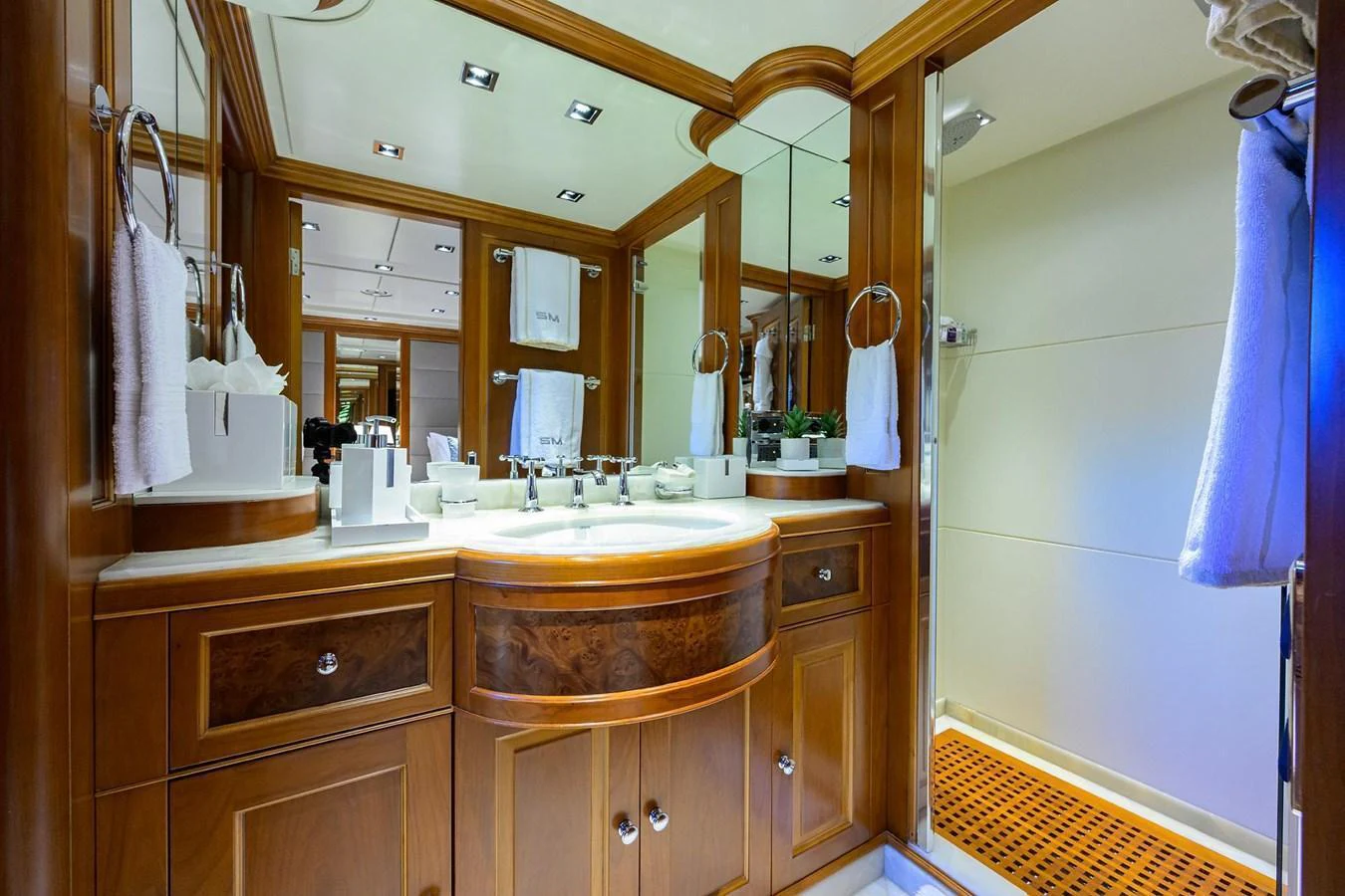 The yacht's bathroom features elegant wood cabinetry and a spacious shower area. aboard BENETTI CLASSIC Yacht for Sale