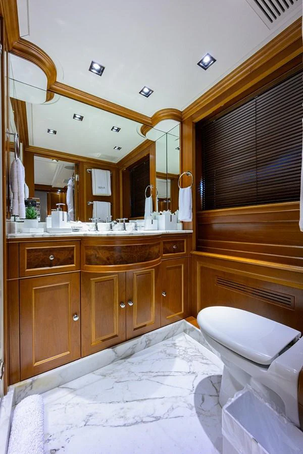 The bathroom features elegant wood cabinetry and marble flooring, creating a luxurious and refined atmosphere. aboard BENETTI CLASSIC Yacht for Sale