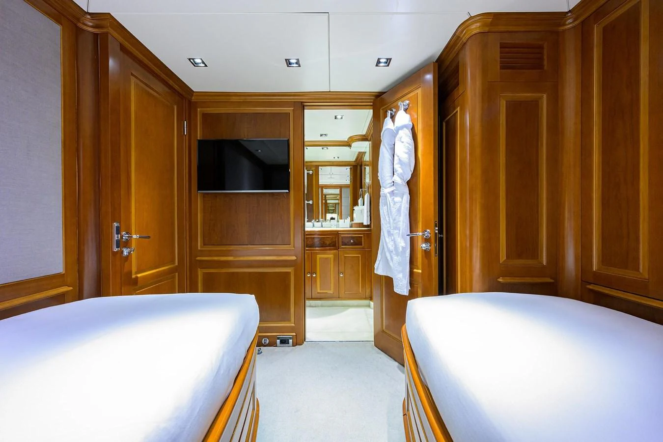 The guest stateroom features twin beds, a flat-screen TV, and an ensuite bathroom with luxurious amenities. aboard BENETTI CLASSIC Yacht for Sale