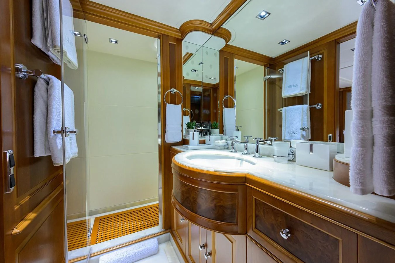 The yacht's bathroom features elegant wood paneling and a spacious vanity area. aboard BENETTI CLASSIC Yacht for Sale