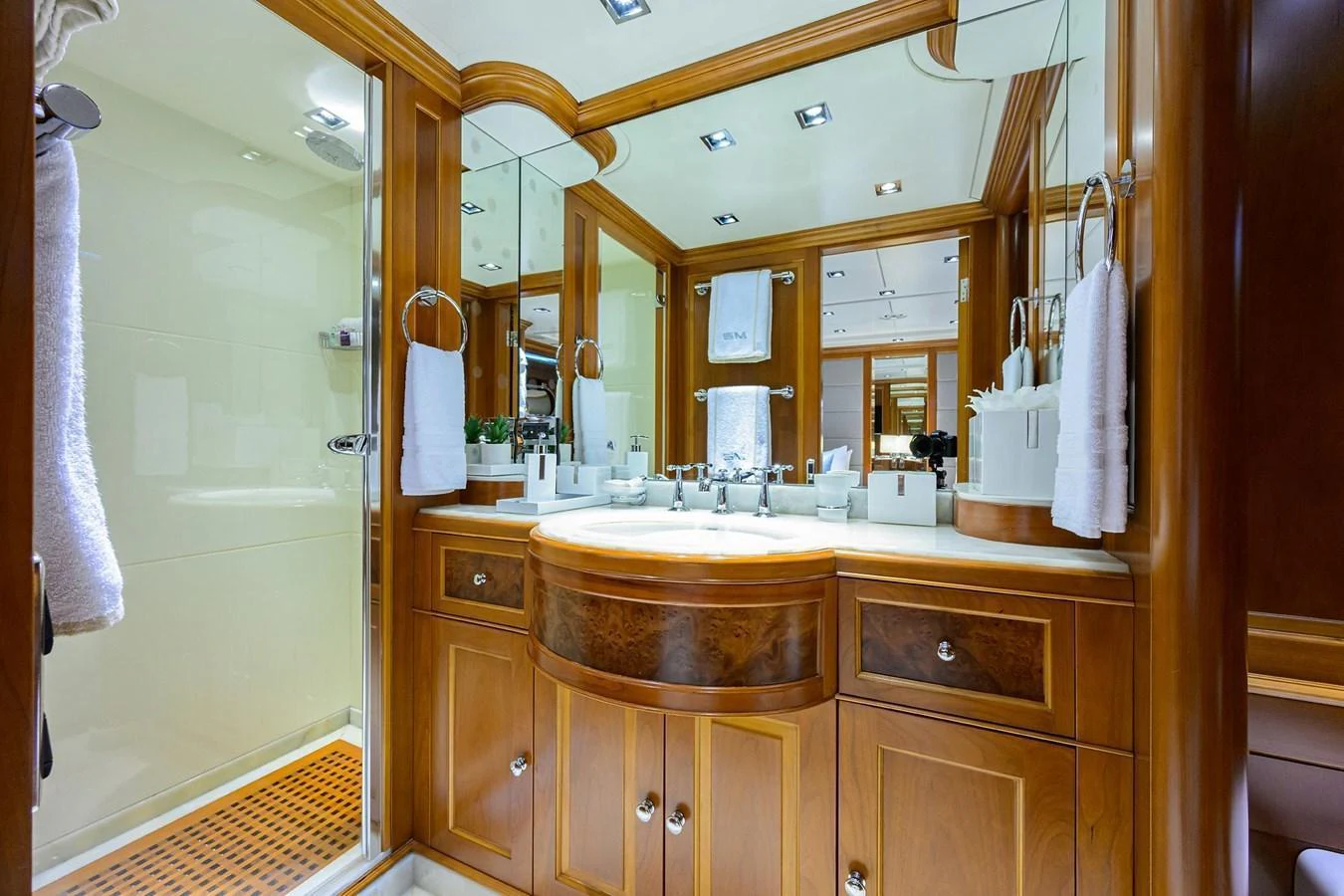 The yacht's bathroom features elegant wood cabinetry and a spacious shower area. aboard BENETTI CLASSIC Yacht for Sale