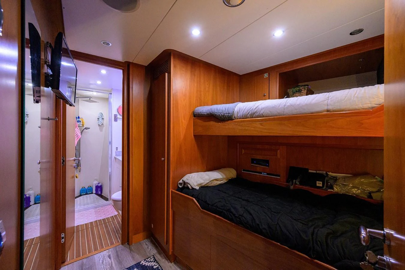A cozy cabin with bunk beds and warm wooden finishes. aboard BENETTI CLASSIC Yacht for Sale