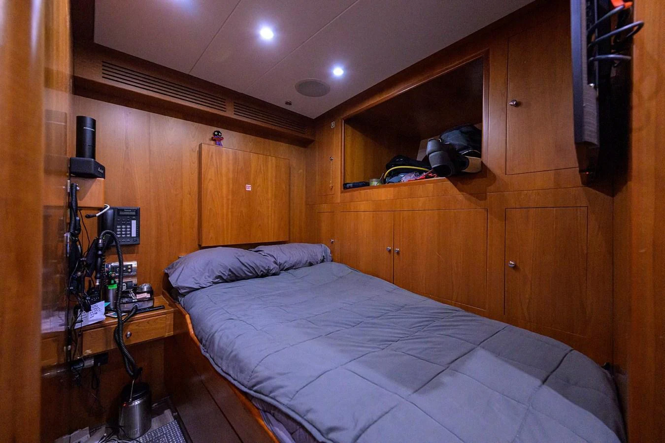 The crew cabin features a comfortable bed and practical storage solutions in a cozy wooden setting. aboard BENETTI CLASSIC Yacht for Sale