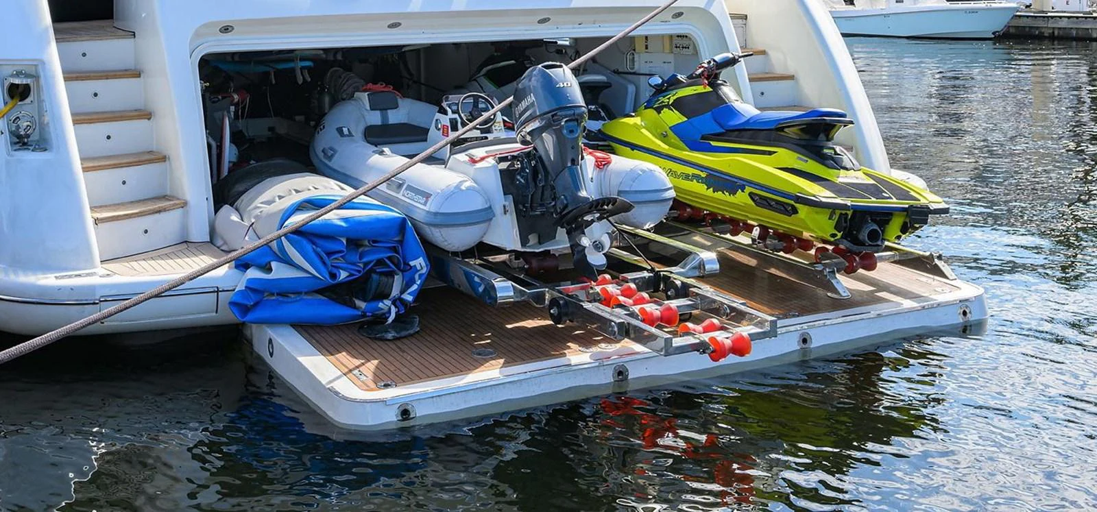 The yacht's garage is equipped with various water toys, including a jet ski and an inflatable boat, ready for adventure. aboard BENETTI CLASSIC Yacht for Sale