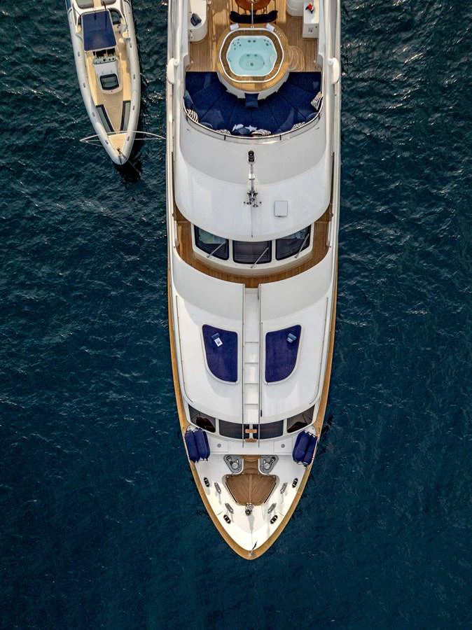 Aerial view of a luxurious yacht with a jacuzzi on the sundeck, anchored in calm waters. aboard SEA BLUEZ Yacht for Sale