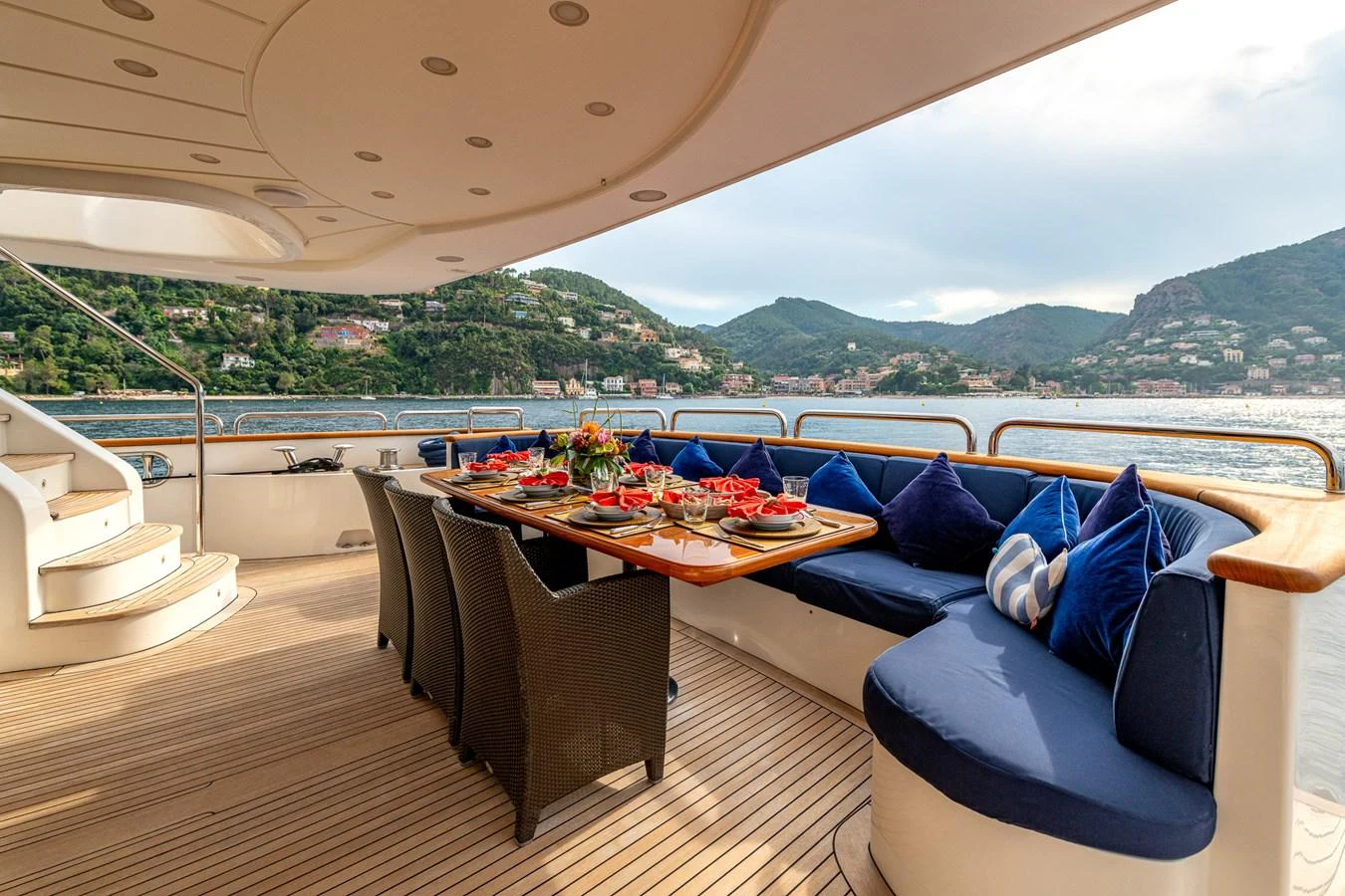 The aft deck features a beautifully set dining area with a stunning view of the coastline. aboard SEA BLUEZ Yacht for Sale