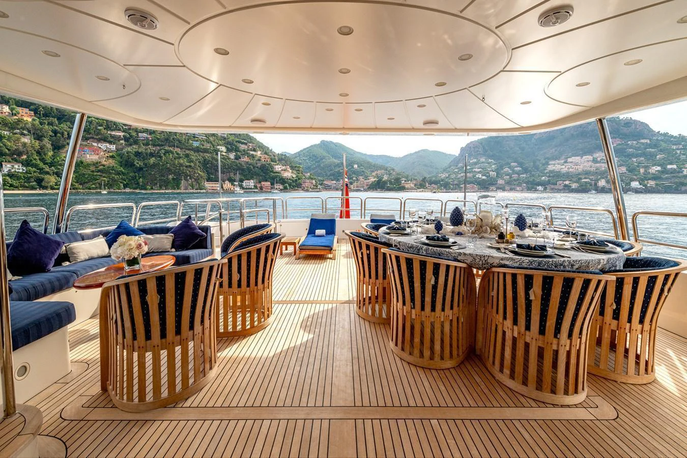 The aft deck features a luxurious dining area with panoramic views of the surrounding waters and landscape. aboard SEA BLUEZ Yacht for Sale