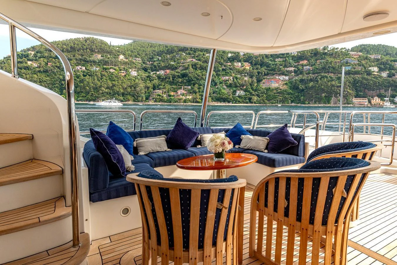 The aft deck features a cozy seating area with plush cushions and a scenic view. aboard SEA BLUEZ Yacht for Sale