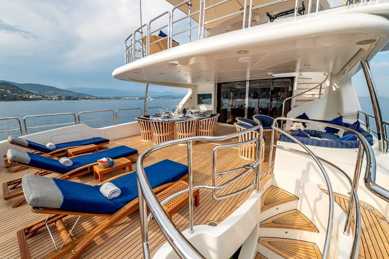 The spacious aft deck features luxurious sun loungers and a stylish dining area, perfect for relaxation and entertaining. aboard SEA BLUEZ Yacht for Sale