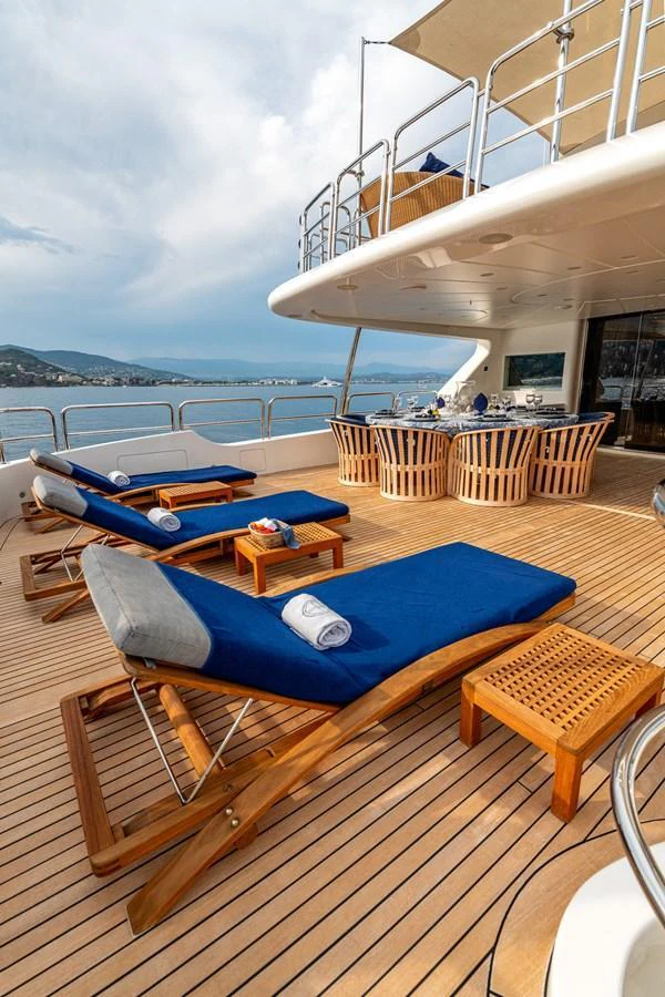 The sundeck features luxurious sun loungers and a dining area with stunning ocean views. aboard SEA BLUEZ Yacht for Sale