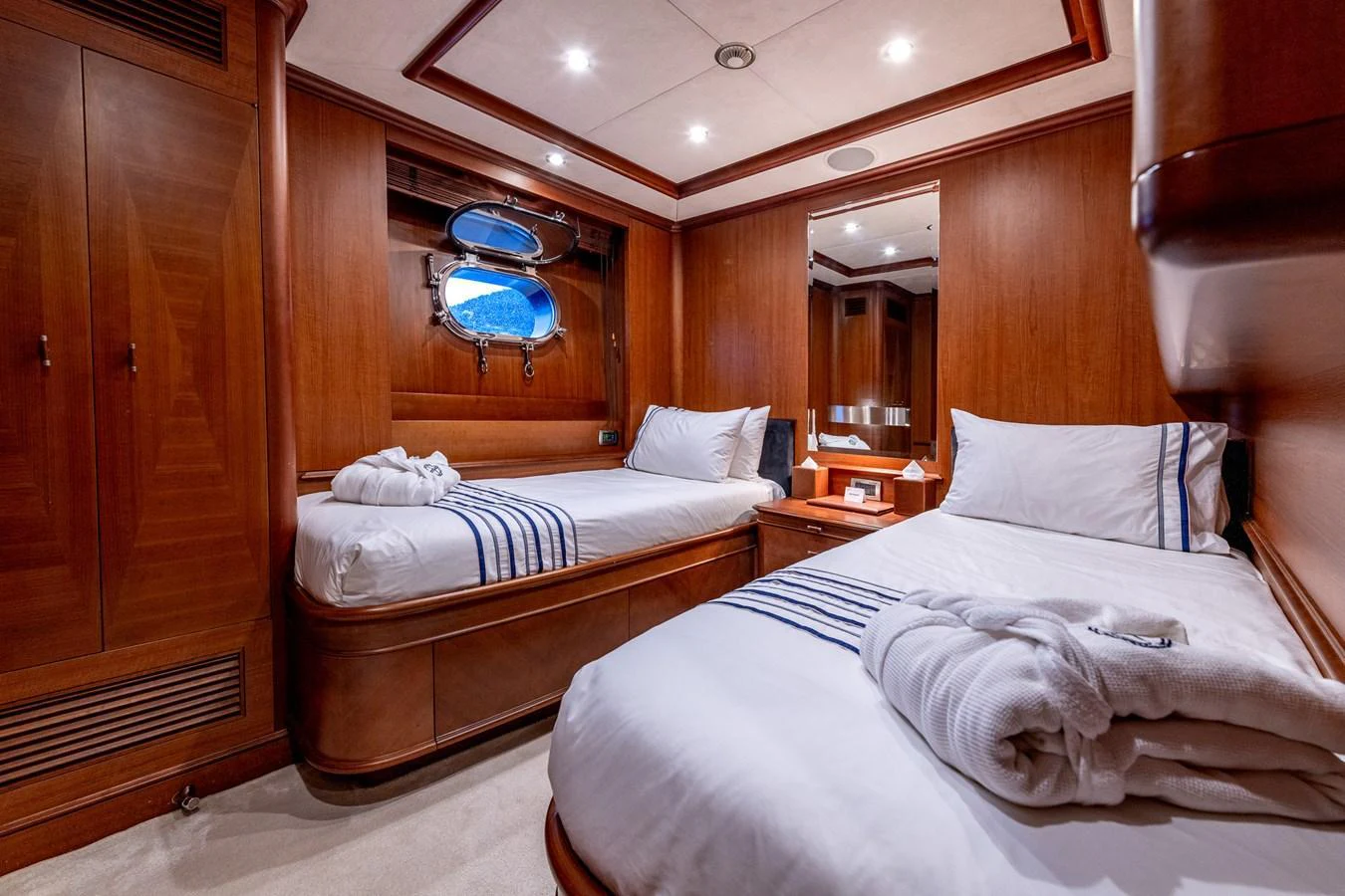 The guest stateroom features twin beds with luxurious linens and warm wooden finishes. aboard SEA BLUEZ Yacht for Sale