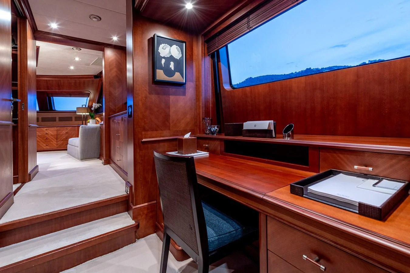 The yacht's office features a sleek wooden desk with a comfortable chair, offering a serene workspace with a view. aboard SEA BLUEZ Yacht for Sale