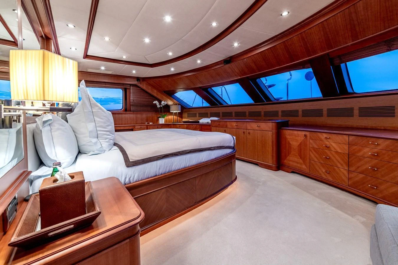 The master stateroom features luxurious wood finishes and expansive windows for a serene retreat. aboard SEA BLUEZ Yacht for Sale