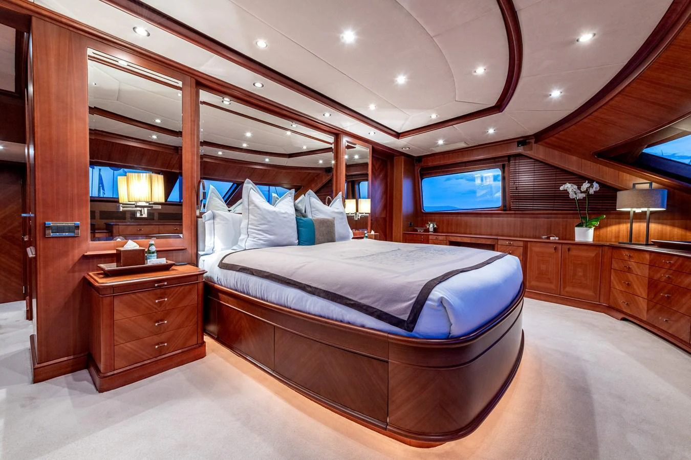 The master stateroom features elegant wood paneling and a luxurious bed with ample natural light. aboard SEA BLUEZ Yacht for Sale