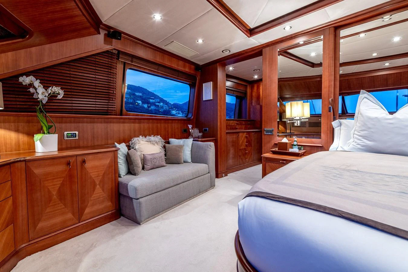 The master stateroom features luxurious wood paneling, a comfortable seating area, and large windows with scenic views. aboard SEA BLUEZ Yacht for Sale