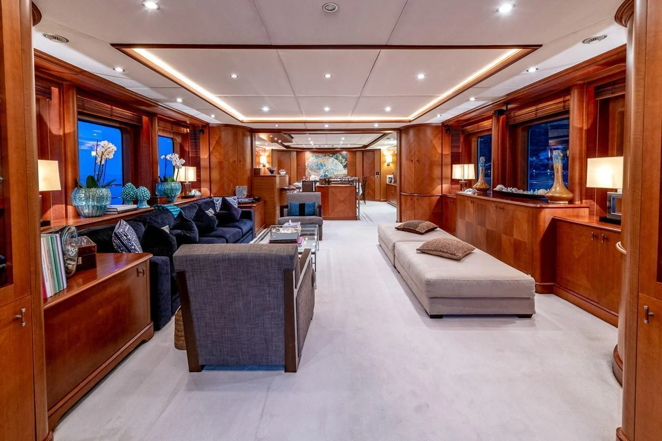 The spacious salon features luxurious seating and elegant wooden finishes, creating a warm and inviting atmosphere. aboard SEA BLUEZ Yacht for Sale