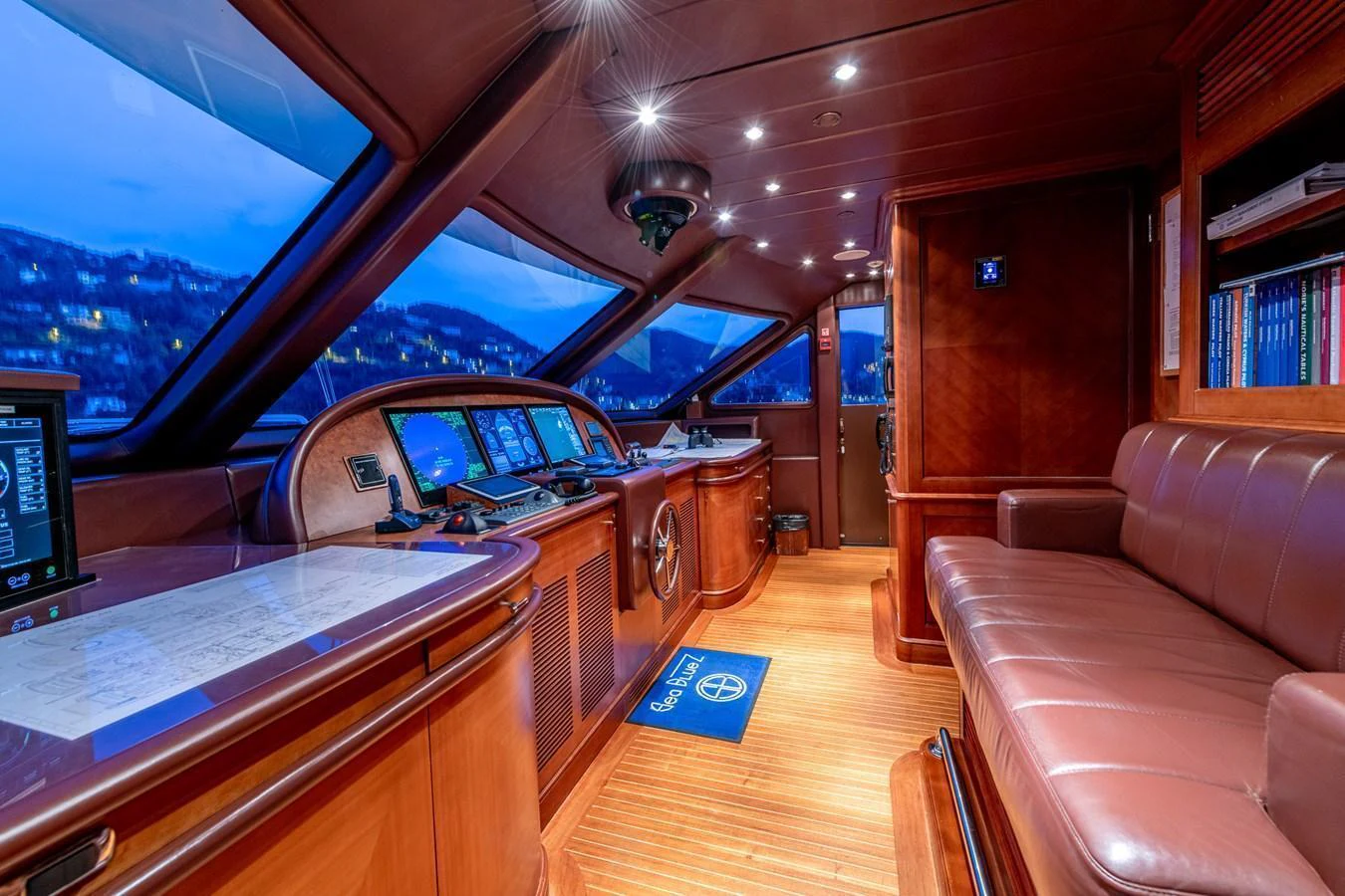 The helm station features luxurious wood finishes and state-of-the-art navigation equipment. aboard SEA BLUEZ Yacht for Sale