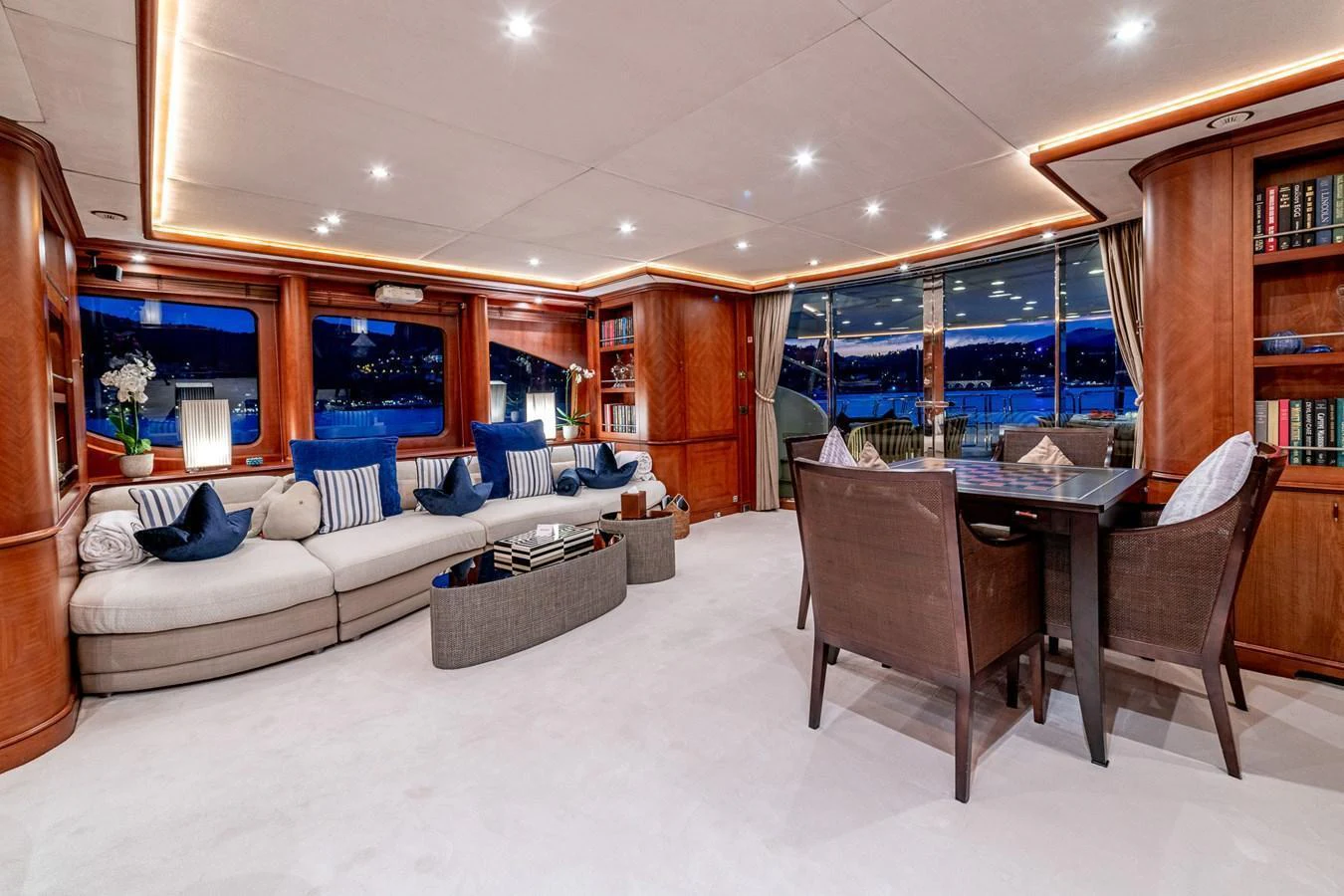 The yacht's salon features elegant wood paneling, plush seating, and large windows offering stunning views. aboard SEA BLUEZ Yacht for Sale