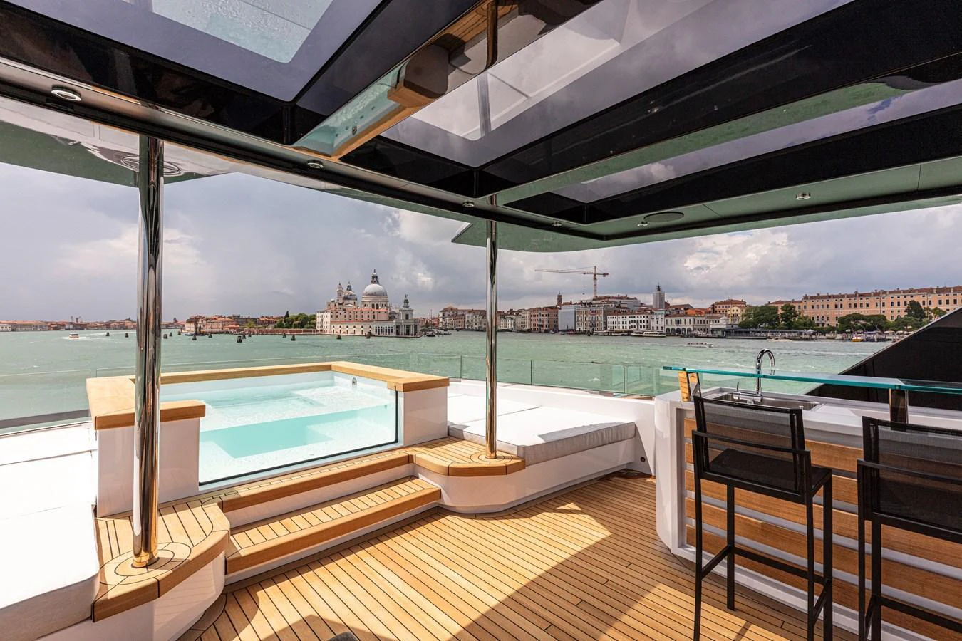 The sundeck features a luxurious hot tub and a stylish bar area with stunning views of the surrounding cityscape. aboard DUCALE 120 Yacht for Sale