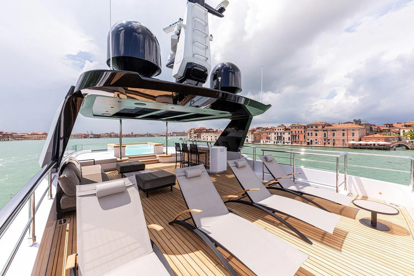 The sundeck offers luxurious lounging with multiple sunbeds and a shaded area for relaxation. aboard DUCALE 120 Yacht for Sale