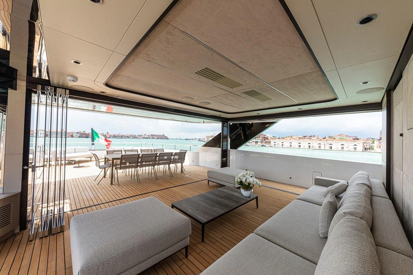 The aft deck features a spacious and elegant seating area with a view of the water. aboard DUCALE 120 Yacht for Sale