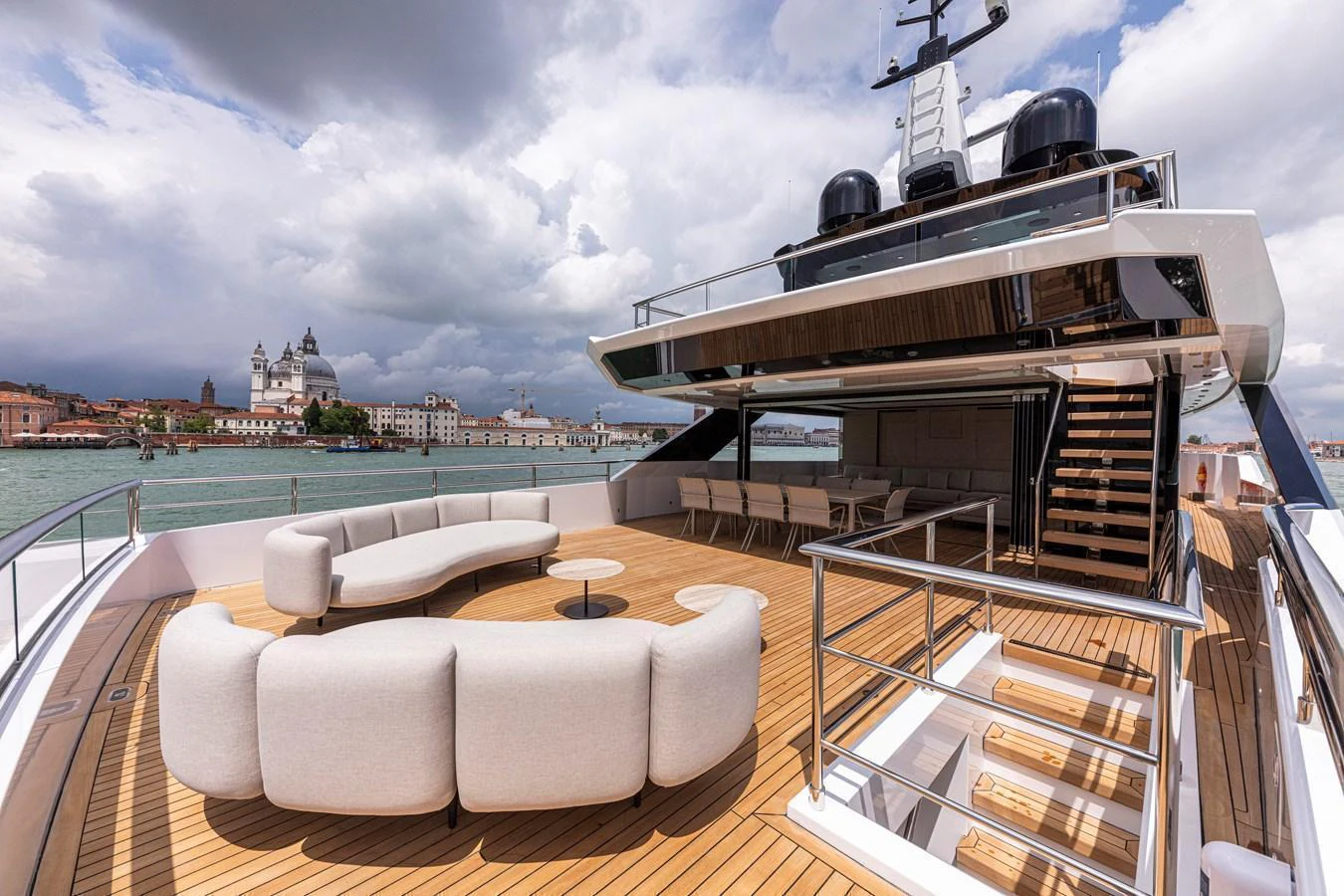 The yacht's spacious aft deck features elegant seating and a stunning view of the surrounding architecture. aboard DUCALE 120 Yacht for Sale
