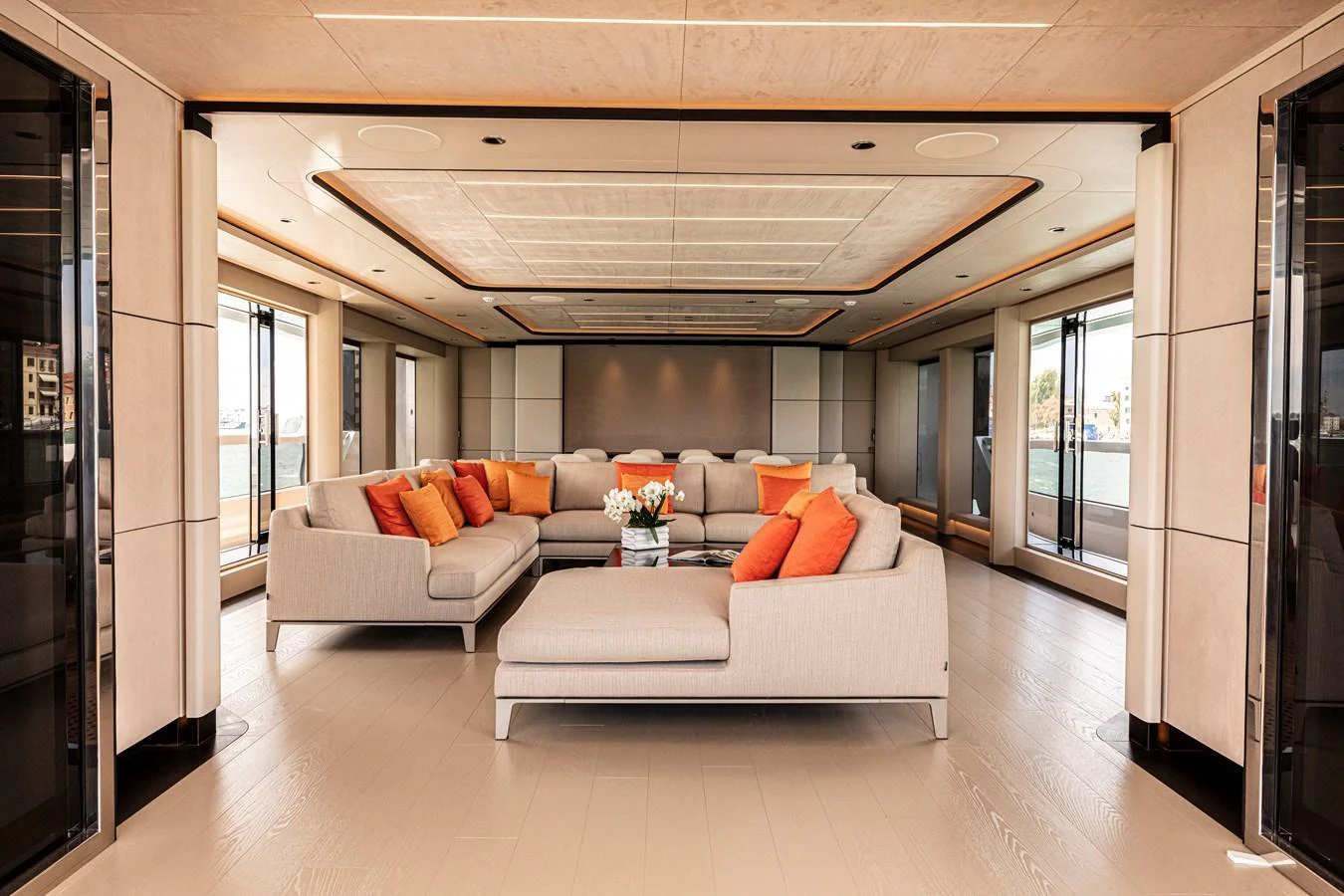 The spacious salon features plush seating with vibrant orange accents, offering a luxurious and inviting atmosphere. aboard DUCALE 120 Yacht for Sale