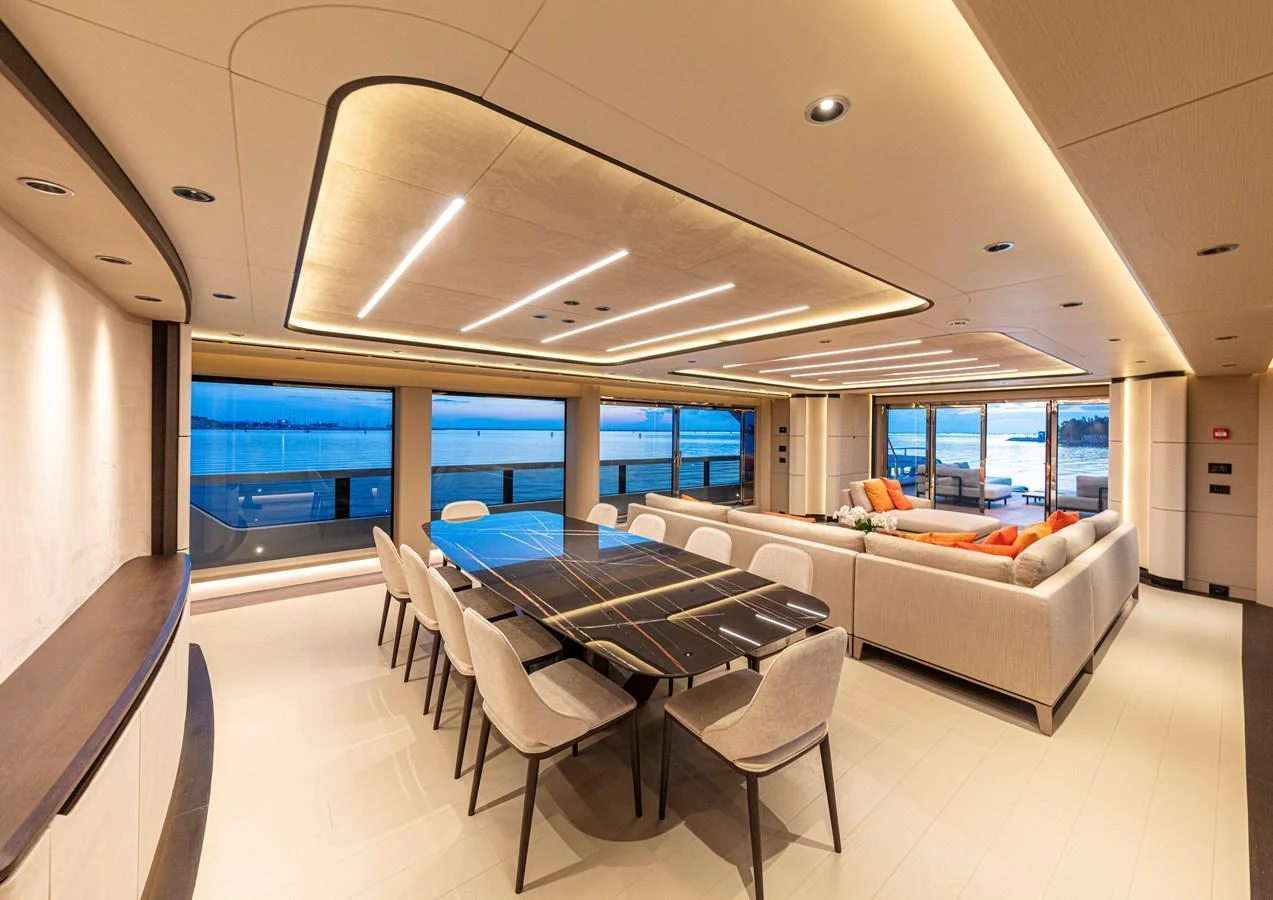 The spacious salon features elegant dining and comfortable lounging areas with panoramic views. aboard DUCALE 120 Yacht for Sale