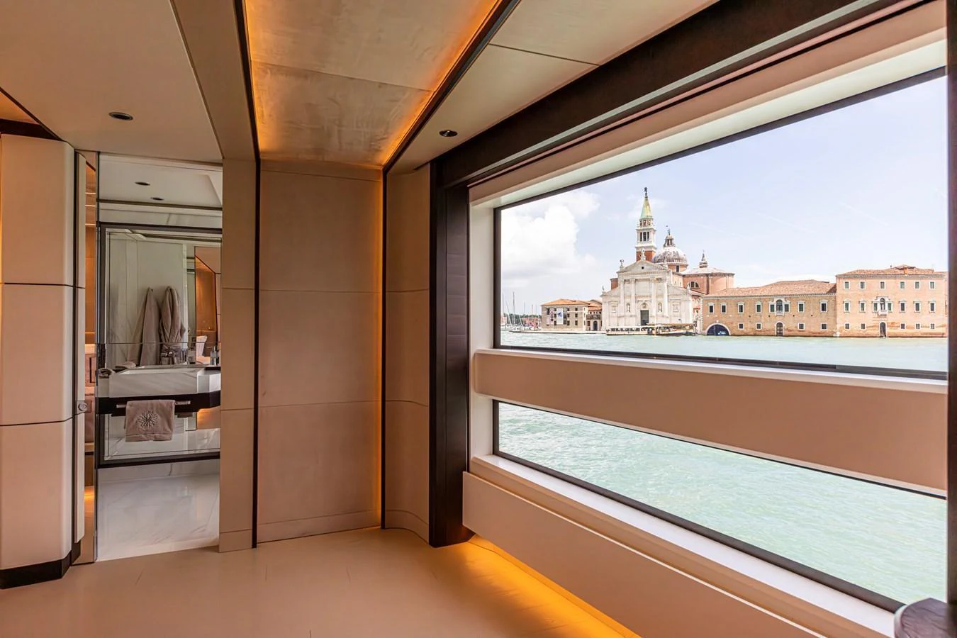 The yacht's interior features large windows offering a stunning view of a historic waterfront. aboard DUCALE 120 Yacht for Sale