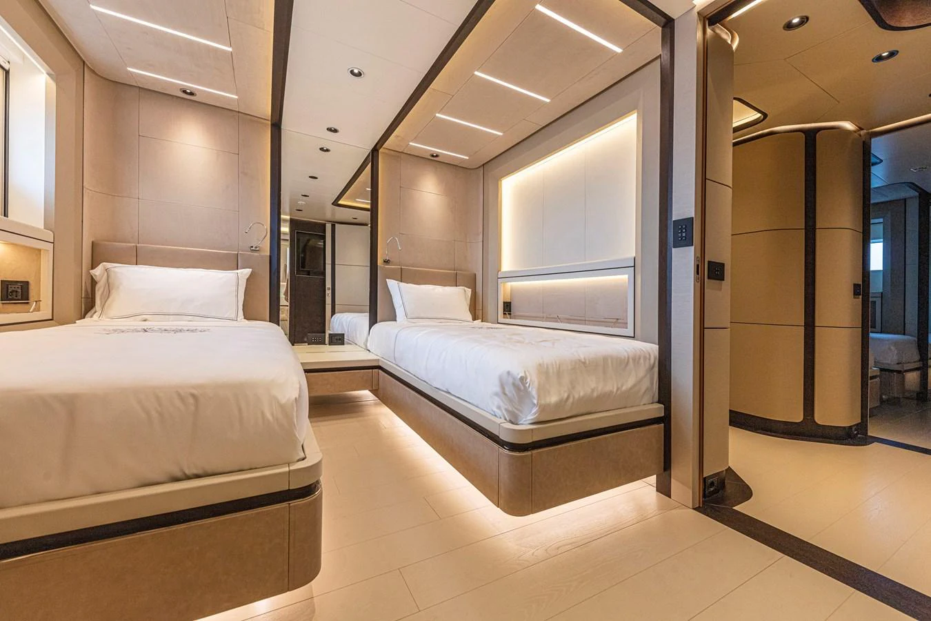 The guest stateroom features two single beds with modern, elegant decor and ample lighting. aboard DUCALE 120 Yacht for Sale