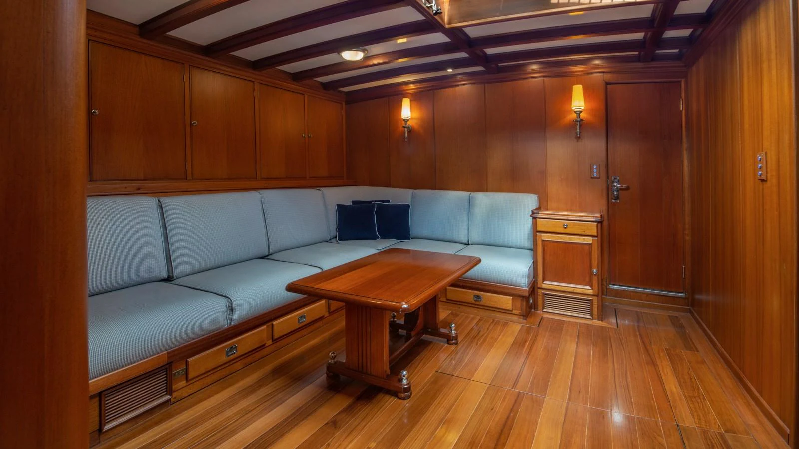The salon features elegant wooden paneling and comfortable seating, creating a warm and inviting atmosphere. aboard CANDIDA Yacht for Sale