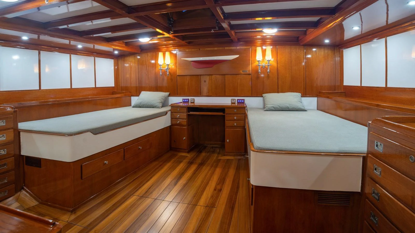 The cabin features twin beds with elegant wooden finishes and soft lighting. aboard CANDIDA Yacht for Sale