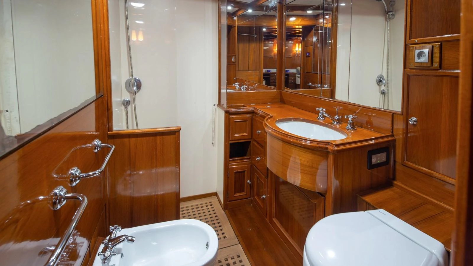 The yacht's bathroom features elegant wood paneling and modern fixtures. aboard CANDIDA Yacht for Sale