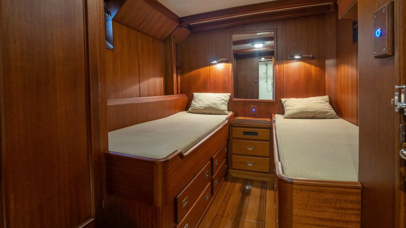 The twin stateroom features rich wood paneling and comfortable twin beds. aboard CANDIDA Yacht for Sale