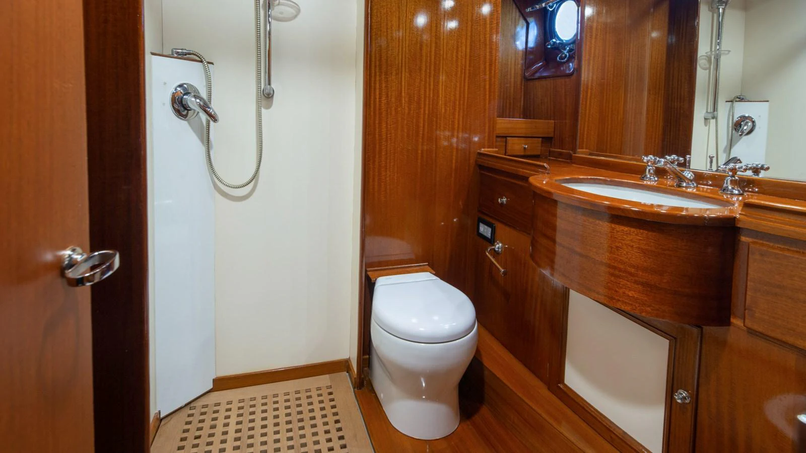 The yacht's bathroom features elegant wooden cabinetry and modern fixtures. aboard CANDIDA Yacht for Sale