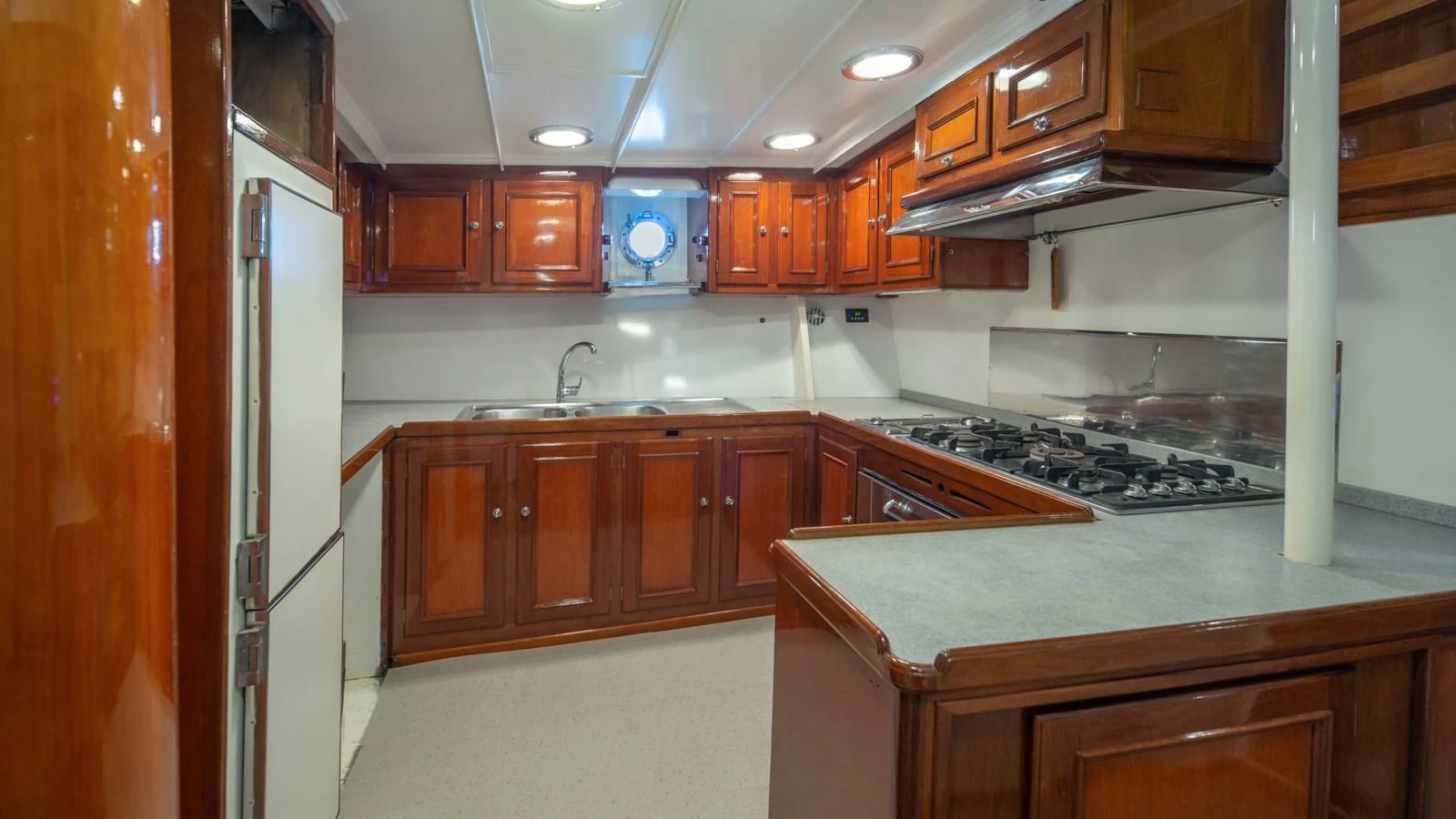 The yacht's galley features polished wood cabinetry and modern appliances, offering a functional and stylish cooking space. aboard CANDIDA Yacht for Sale
