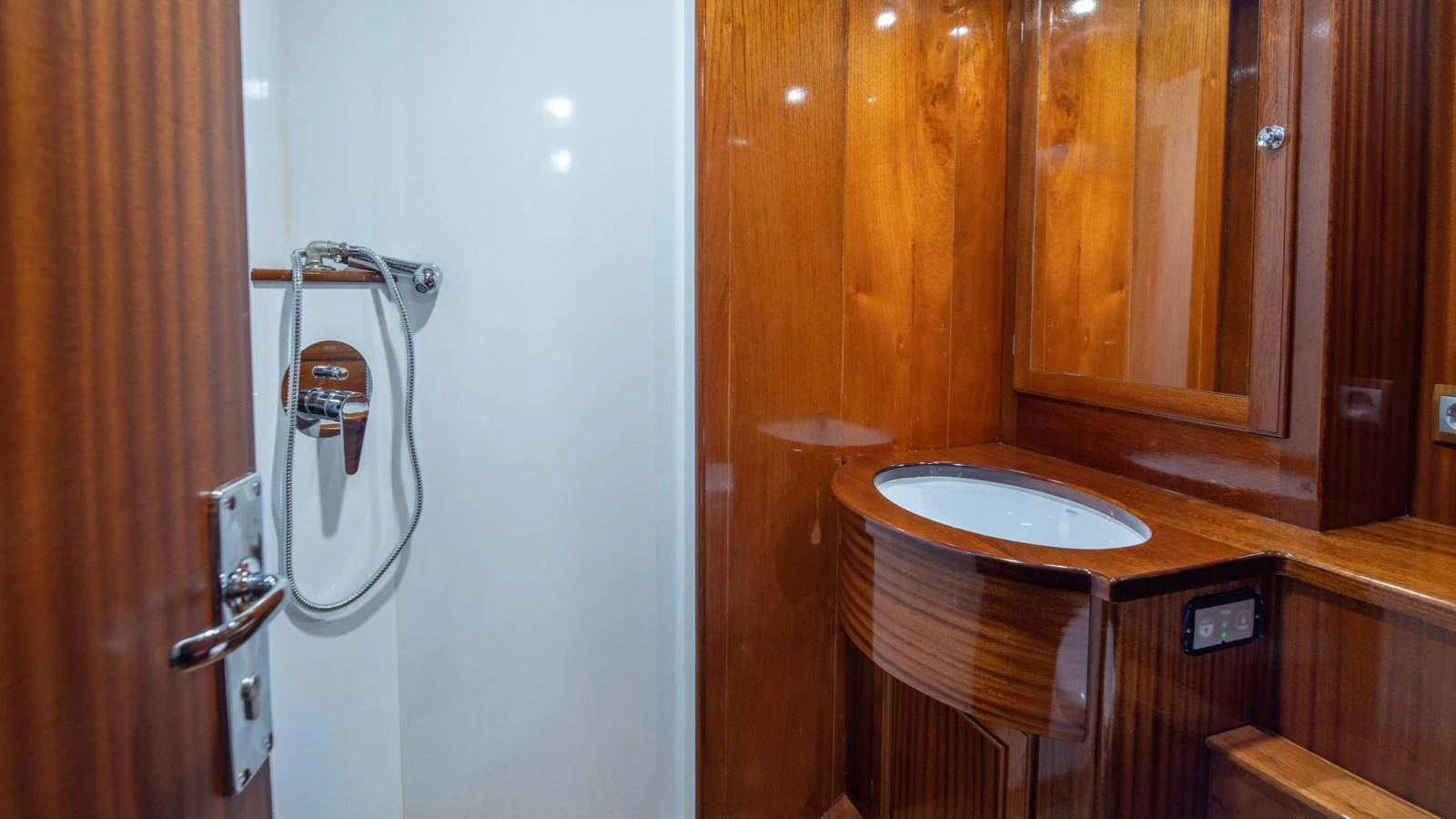 The yacht's bathroom features elegant wooden finishes and modern fixtures. aboard CANDIDA Yacht for Sale